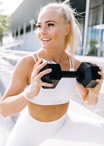 MacKayla exercising with a dumbbell